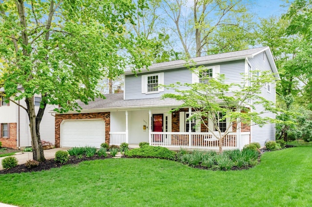 traditional-style home featuring concrete driveway, a front yard, covered porch, and a garage