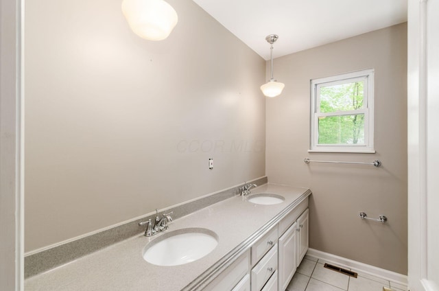bathroom with tile patterned floors, visible vents, a sink, and double vanity