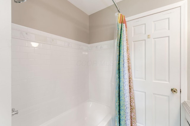 bathroom with shower / bathtub combination with curtain