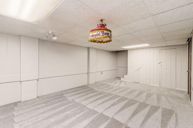 finished basement with a drop ceiling and carpet floors