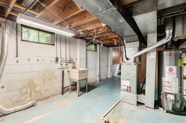 basement with water heater and a sink
