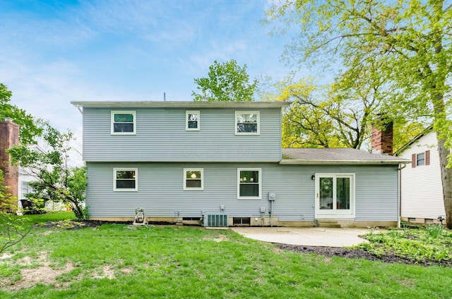 rear view of house featuring central AC, a yard, a chimney, and a patio