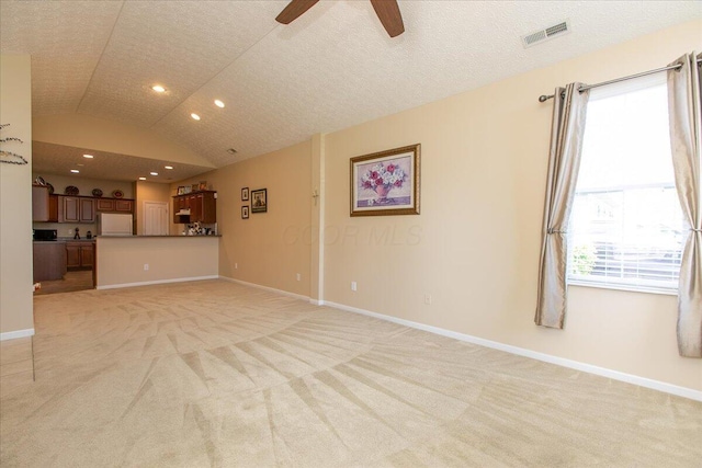 6227 Stonewalk Ln, New Albany, OH 43054 - unfurnished living room featuring a ceiling fan, visible vents, light carpet, lofted ceiling, and recessed lighting