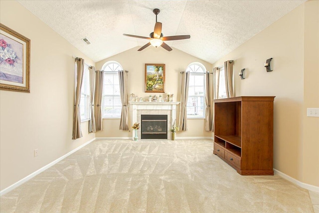 6227 Stonewalk Ln, New Albany, OH 43054 - carpeted living room featuring a textured ceiling, visible vents, a fireplace, and ceiling fan