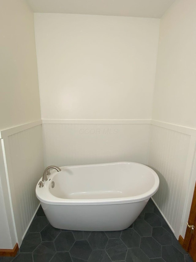 4344 N US Highway 68, West Liberty, OH 43357 - bathroom with tile patterned floors, wainscoting, and a freestanding tub