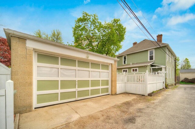 661-663 Beech St, Columbus, OH 43206 - view of front of home featuring an outdoor structure, a detached garage, and fence
