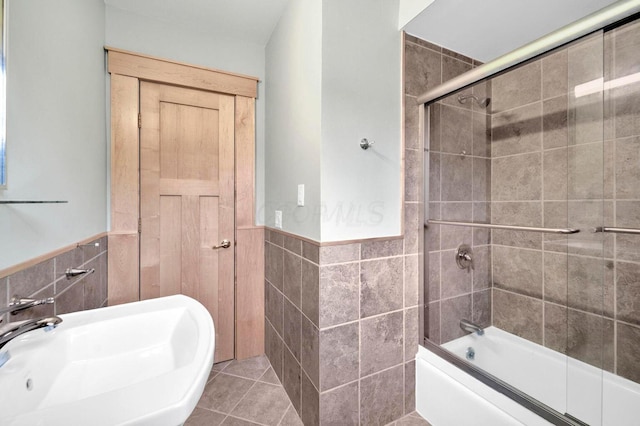 661-663 Beech St, Columbus, OH 43206 - bathroom featuring tile walls, wainscoting, a sink, enclosed tub / shower combo, and tile patterned flooring