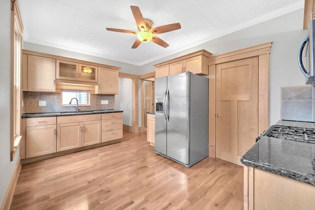 661-663 Beech St, Columbus, OH 43206 - kitchen with stainless steel appliances, a sink, light brown cabinetry, light wood-type flooring, and crown molding