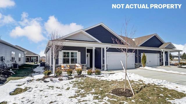 view of front of house featuring concrete driveway, stone siding, a porch, and an attached garage