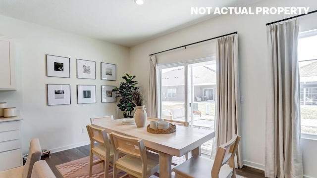 dining space with baseboards, plenty of natural light, and dark wood finished floors