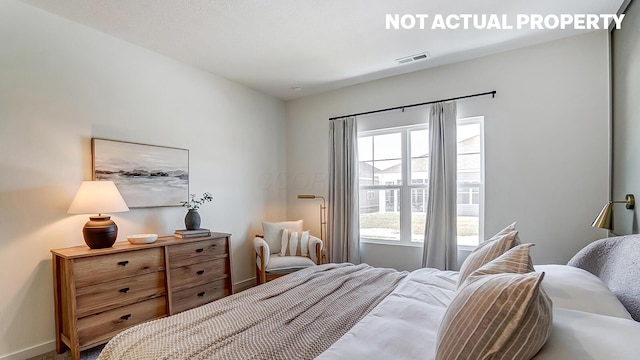 bedroom featuring visible vents and baseboards