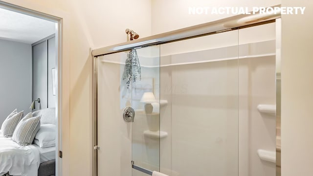full bathroom featuring ensuite bathroom and a shower stall