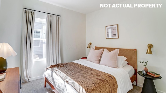 carpeted bedroom featuring baseboards