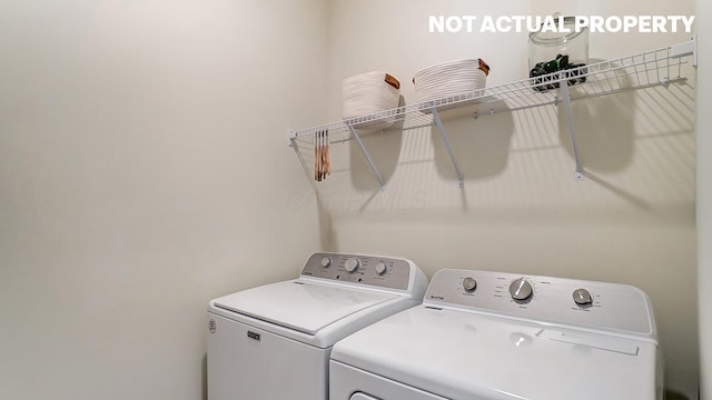 washroom with separate washer and dryer and laundry area