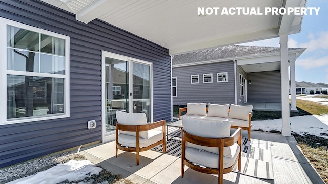 snow covered deck with an outdoor hangout area