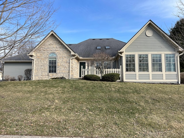 view of front of house with stone siding and a front yard