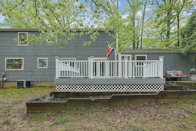 rear view of property featuring a deck and central AC