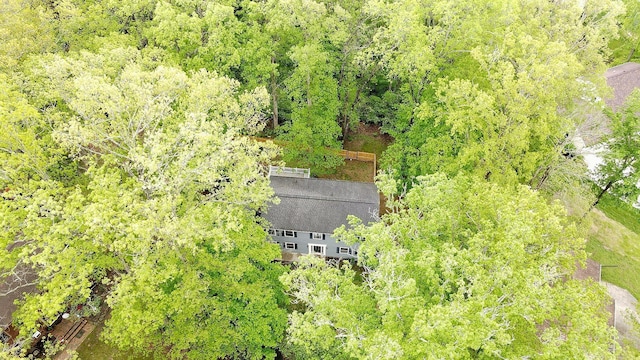 birds eye view of property with a view of trees