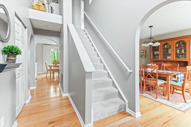 830 Avalon Dr, Pickerington, OH 43147 - staircase featuring arched walkways, wood finished floors, and baseboards