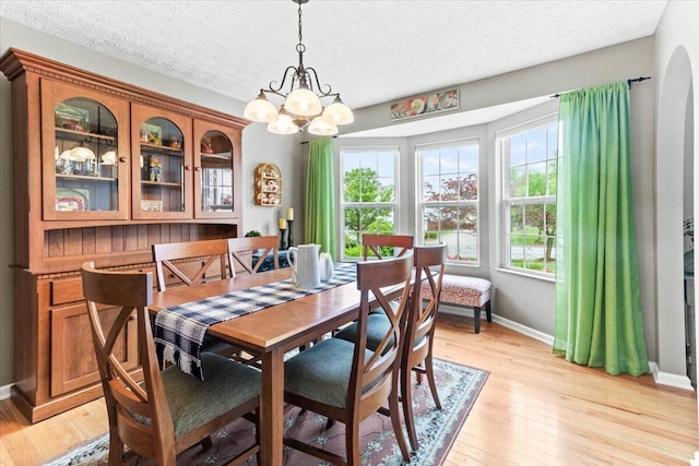 830 Avalon Dr, Pickerington, OH 43147 - dining space featuring baseboards, light wood-style flooring, a chandelier, and a textured ceiling