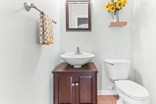 830 Avalon Dr, Pickerington, OH 43147 - half bath featuring toilet, vanity, wood finished floors, and baseboards