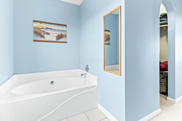 830 Avalon Dr, Pickerington, OH 43147 - bathroom featuring a garden tub, baseboards, and a spacious closet