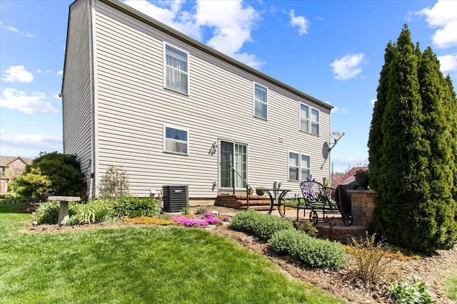 830 Avalon Dr, Pickerington, OH 43147 - back of property with central AC unit, a lawn, and a patio