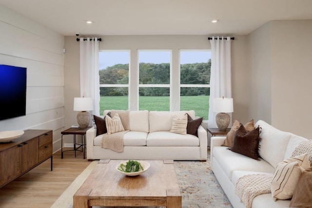 living area with light wood finished floors and recessed lighting