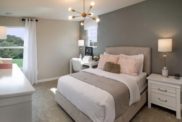 bedroom with light colored carpet, baseboards, and a notable chandelier