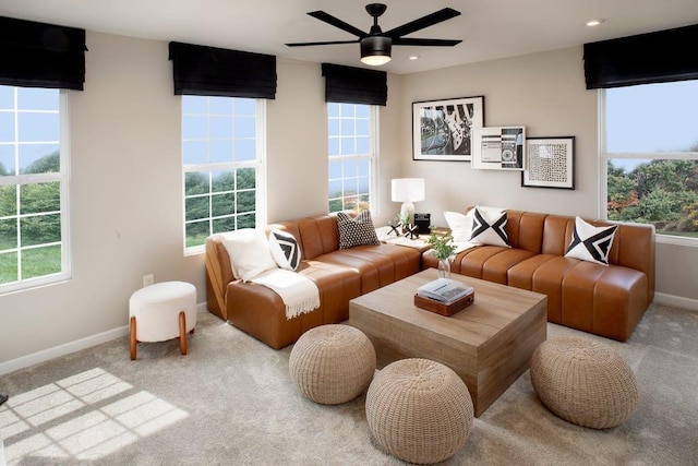 living room featuring baseboards, ceiling fan, and carpet floors