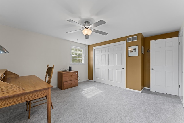 office featuring light colored carpet, visible vents, baseboards, and ceiling fan