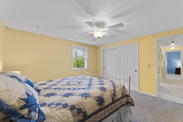 bedroom with carpet, a closet, a ceiling fan, and baseboards