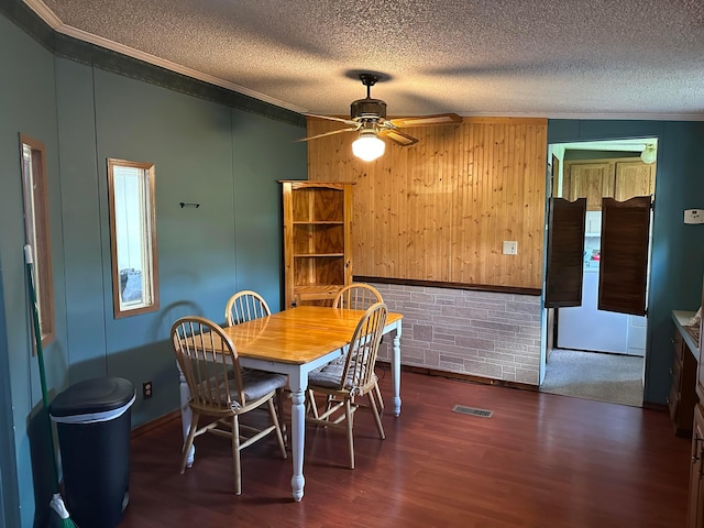 154 Cambridge Ct, Reynoldsburg, OH 43068 - dining room featuring visible vents, dark wood finished floors, crown molding, and a textured ceiling