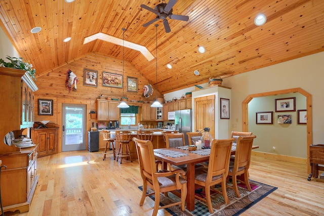 dining area with light wood finished floors, wood ceiling, high vaulted ceiling, and a ceiling fan