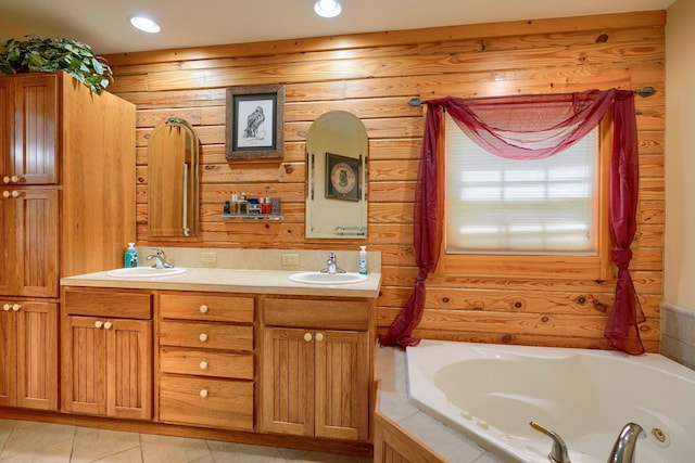 bathroom with a jetted tub, a sink, and recessed lighting
