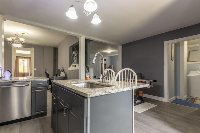 kitchen featuring a notable chandelier, stainless steel dishwasher, dark wood-style flooring, and a sink