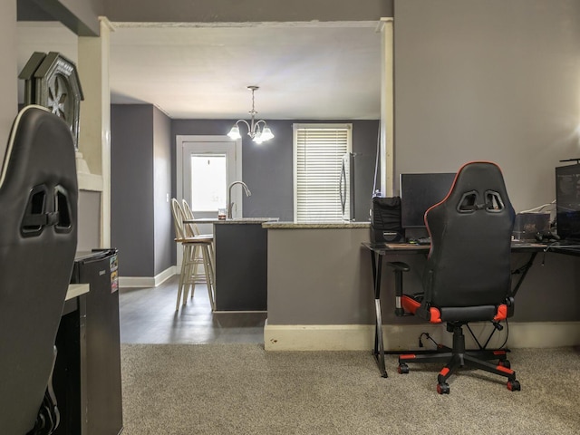office with baseboards, a sink, and a notable chandelier