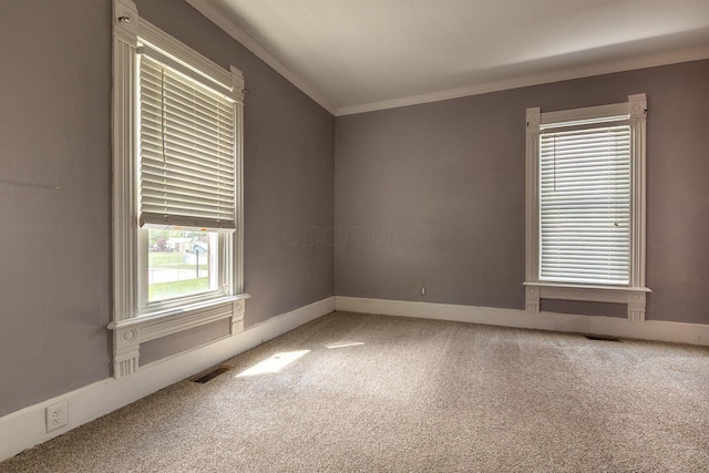 empty room with carpet, baseboards, and ornamental molding