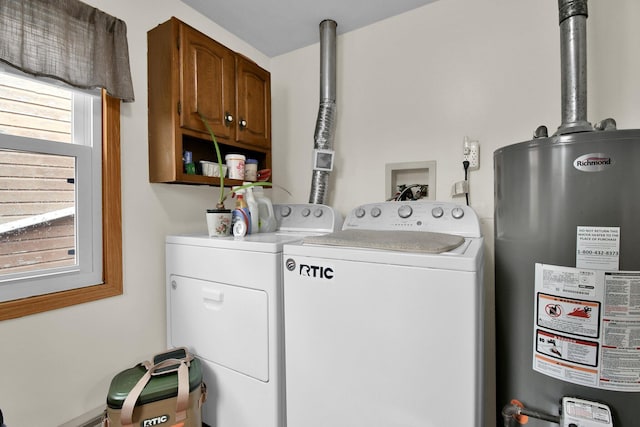 washroom featuring cabinet space, washer and clothes dryer, and gas water heater