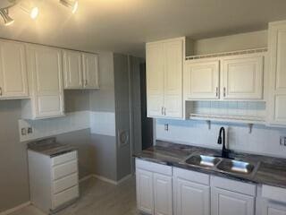 1621 Burley Dr, Columbus, OH 43207 - kitchen featuring a sink, dark countertops, and white cabinetry