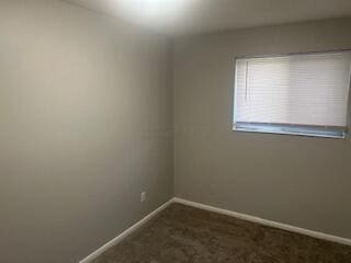 1621 Burley Dr, Columbus, OH 43207 - empty room with baseboards and dark colored carpet