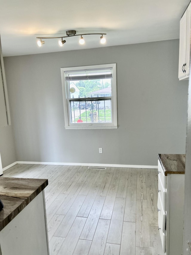 1621 Burley Dr, Columbus, OH 43207 - unfurnished dining area featuring light wood-style flooring and baseboards