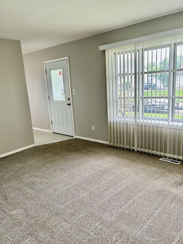 1621 Burley Dr, Columbus, OH 43207 - carpeted foyer entrance with plenty of natural light and baseboards