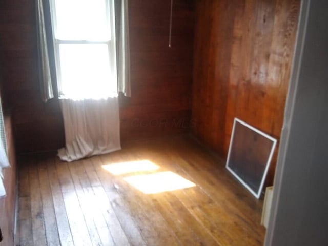 spare room with hardwood / wood-style floors