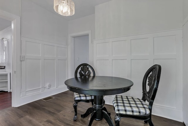 118 Maple St, Hebron, OH 43025 - dining space featuring a decorative wall, a chandelier, and dark wood-style flooring