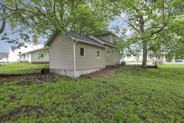 118 Maple St, Hebron, OH 43025 - view of side of home with central AC, a lawn, and roof with shingles