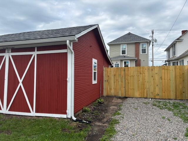 view of outdoor structure with an outbuilding and fence