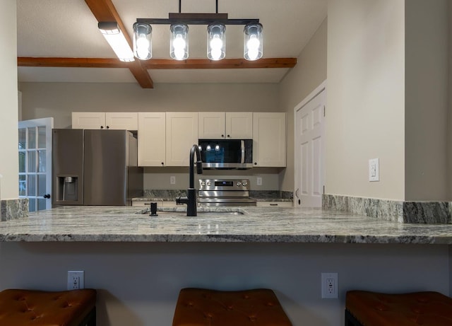 730 Forest Rose Ave, Lancaster, OH 43130 - kitchen with stainless steel appliances, white cabinetry, a sink, light stone countertops, and a peninsula