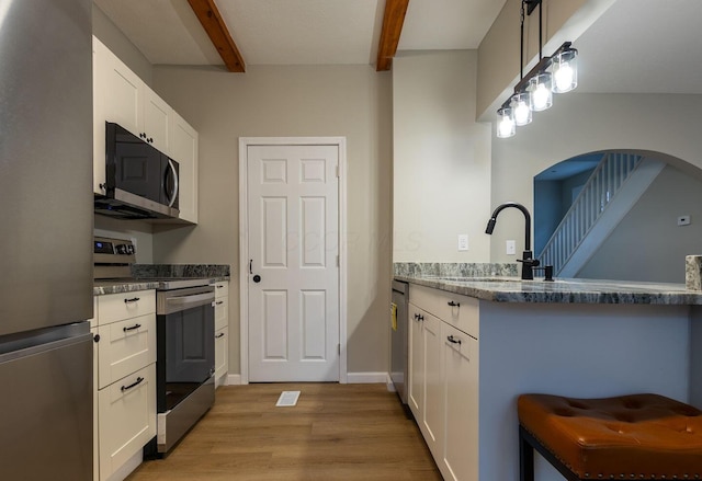 730 Forest Rose Ave, Lancaster, OH 43130 - kitchen featuring stainless steel appliances, a sink, beam ceiling, light wood-style flooring, and white cabinets