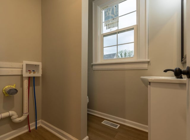 730 Forest Rose Ave, Lancaster, OH 43130 - bathroom featuring wood finished floors, vanity, baseboards, and toilet